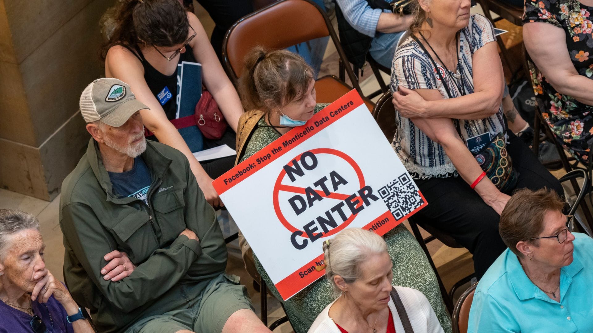 Участники слушаний с плакатом No Data Center против строительства дата-центров